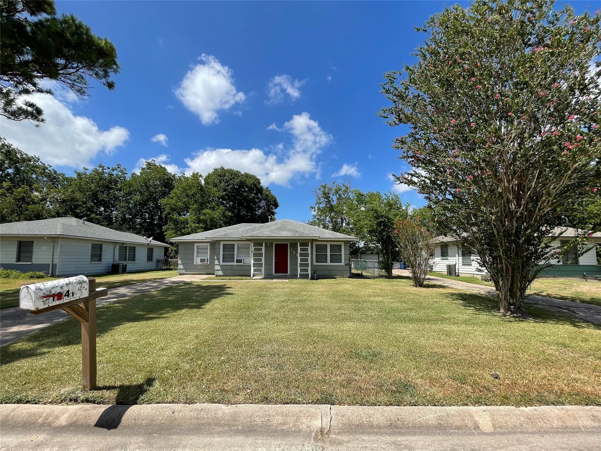 1241 Chevy Chase Drive Angleton, TX 77515 - Photo 1 of 21 a front view of a house with a yard