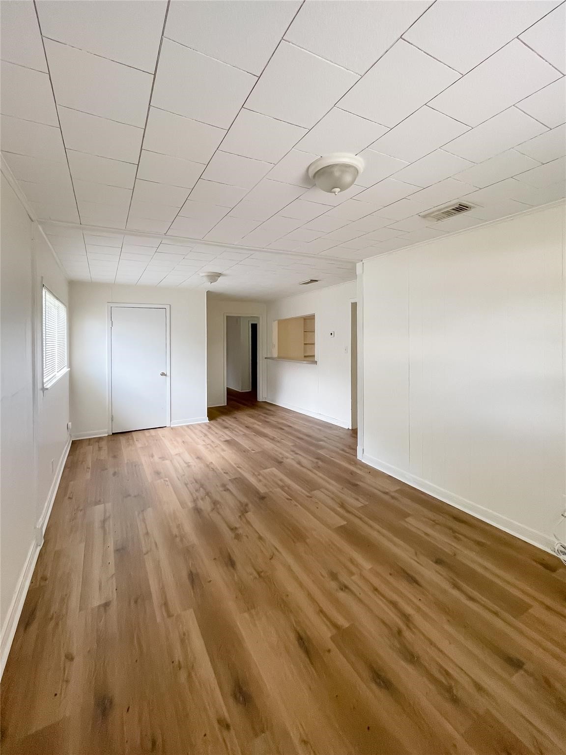 1241 Chevy Chase Drive Angleton, TX 77515 - Photo 11 of 21 a view of an empty room with wooden floor