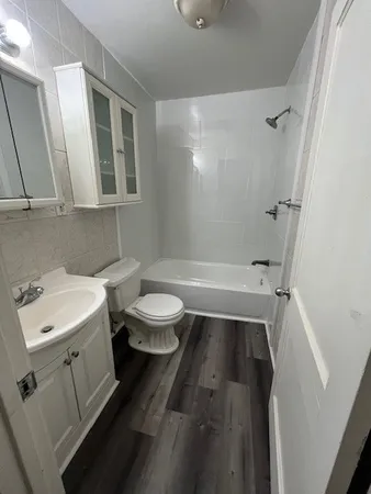 a bathroom with a sink a toilet and a mirror