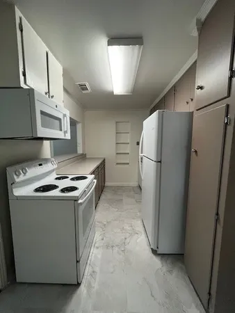 a kitchen with stainless steel appliances a refrigerator a sink a stove and cabinets