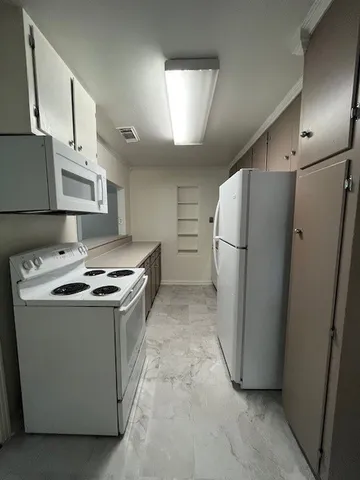 a kitchen with stainless steel appliances a refrigerator a sink a stove and cabinets