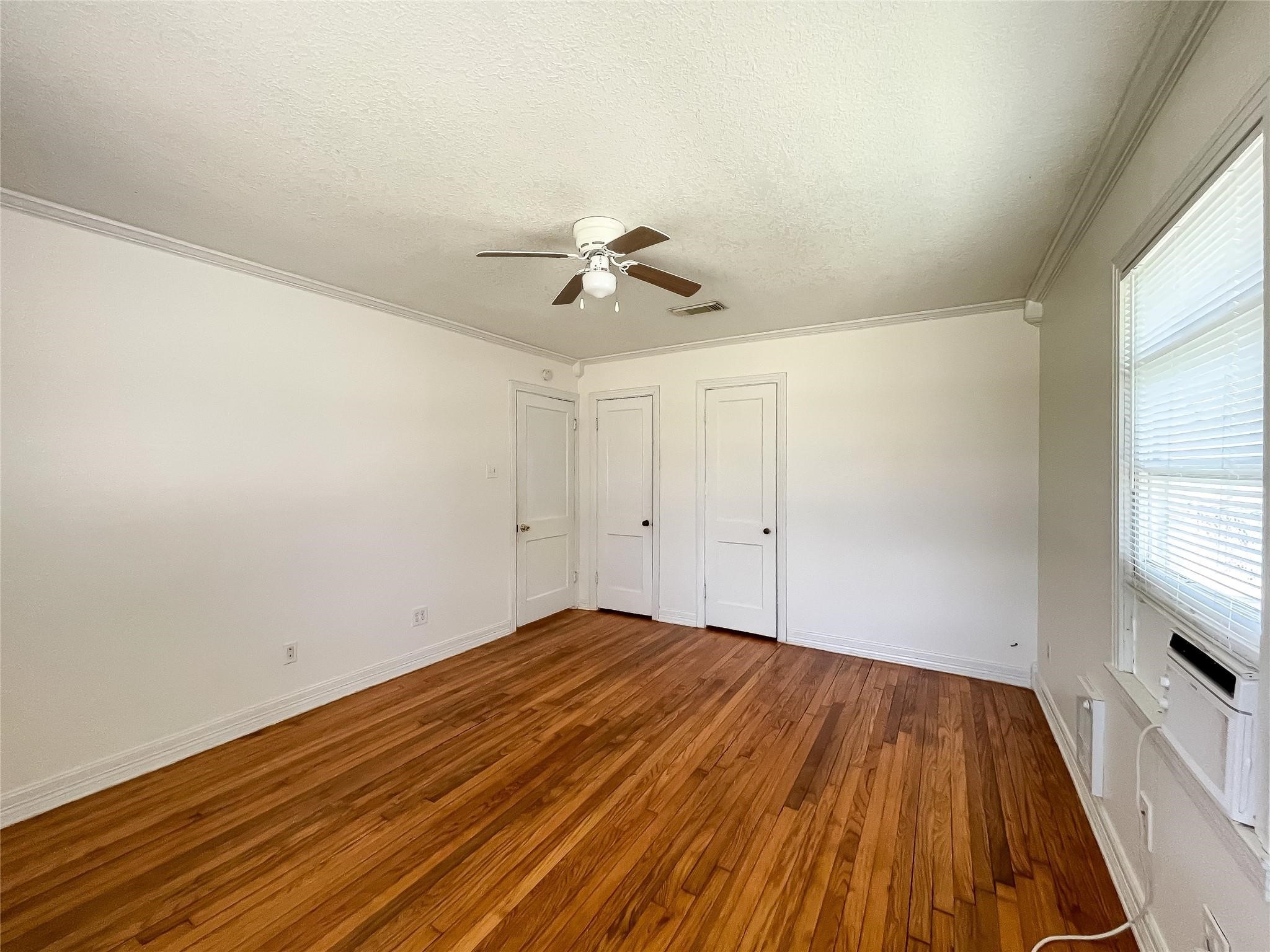 1241 Chevy Chase Drive Angleton, TX 77515 - Photo 5 of 21 wooden floor in an empty room with a window