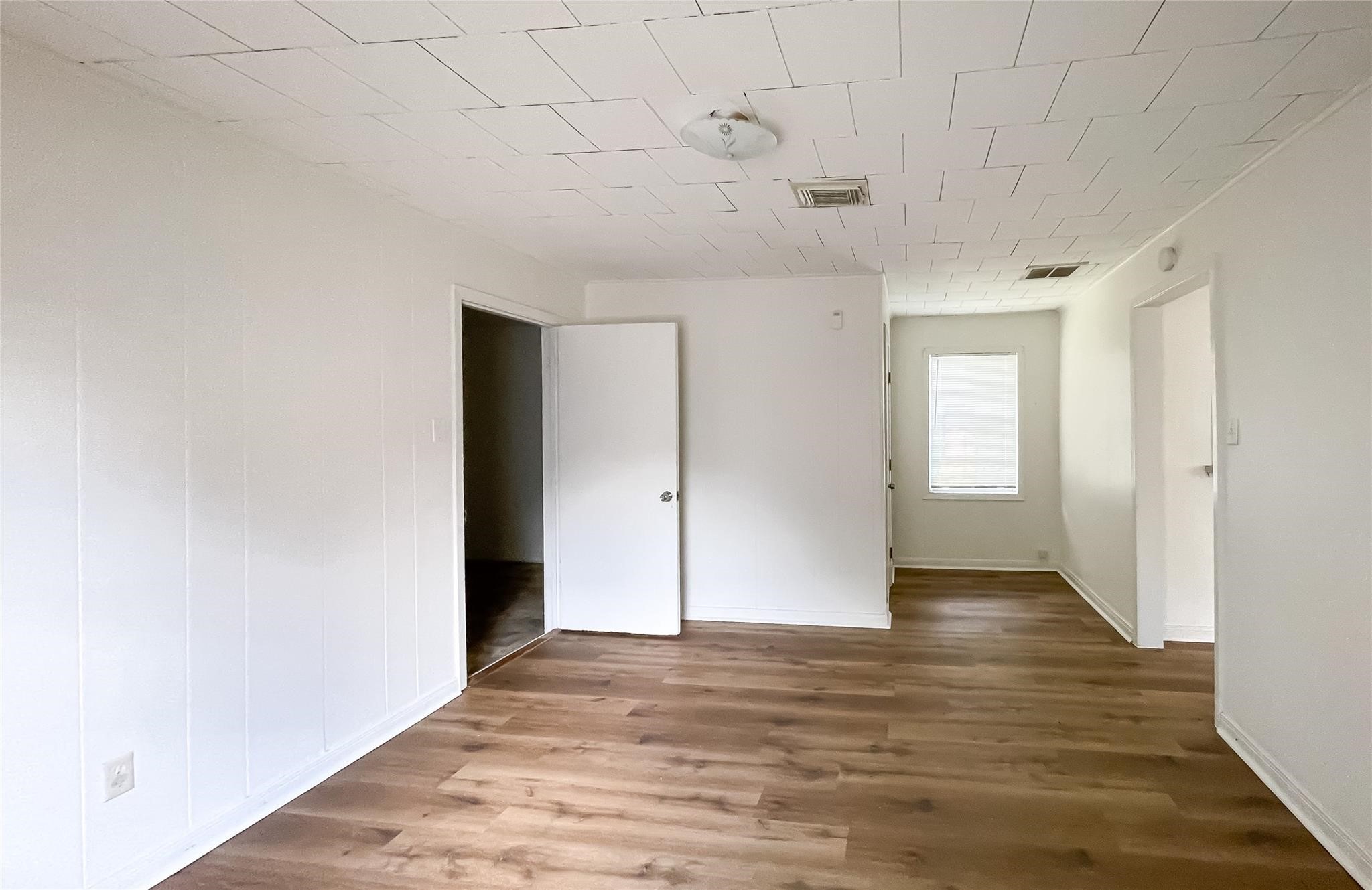 1241 Chevy Chase Drive Angleton, TX 77515 - Photo 8 of 21 a view of an empty room with wooden floor