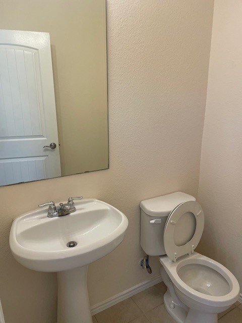 10201 Gertrudis Loop Austin, TX 78747 - Photo 10 of 24 A compact and functional powder room with a sleek pedestal sink and commode.