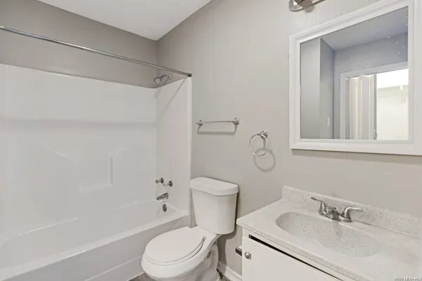 a white toilet sitting next to a bathroom sink