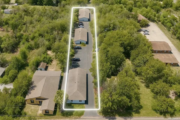 an aerial view of a residential apartment building with a yard