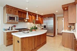 a kitchen with stainless steel appliances a sink stove and refrigerator