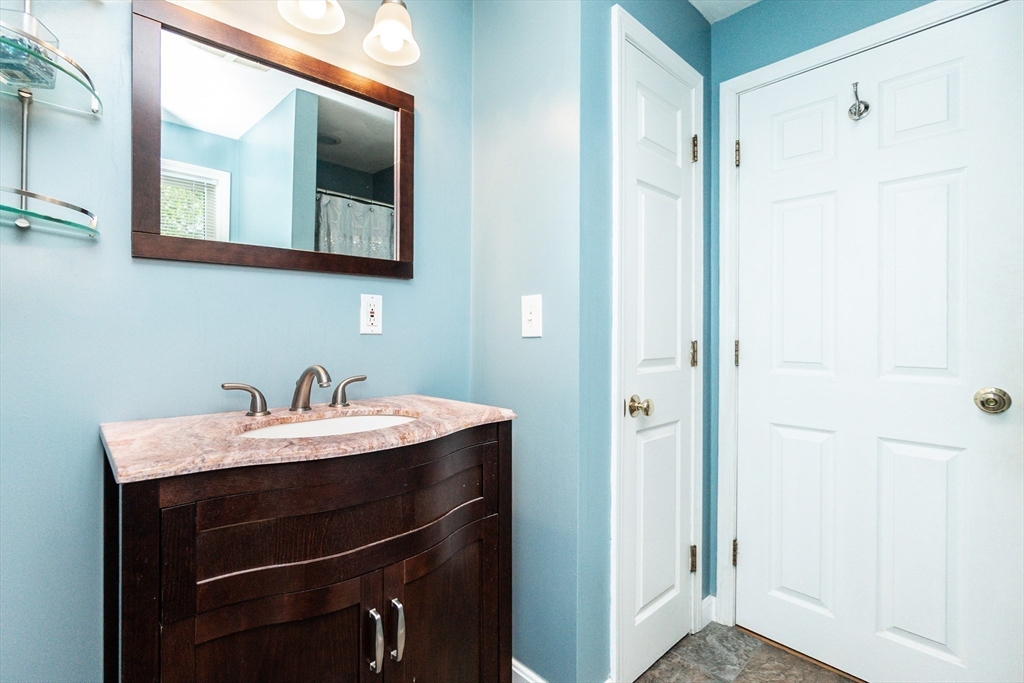 63 Bow Street Saugus, MA 01906 - Photo 24 of 42 a bathroom with a sink and a mirror