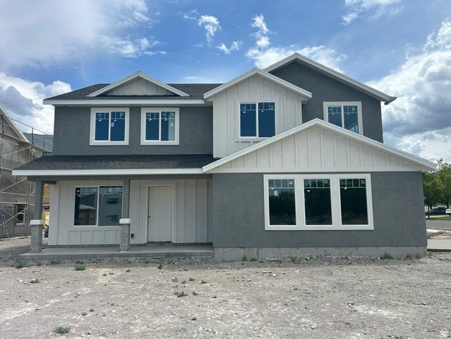 264 North 950th West, Unit LOT 1 Springville, UT 84663 - Photo 1 of 1 Contemporary two-story residence featuring a gray stucco facade and white board-and-batten accents