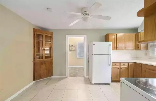 a kitchen with a refrigerator sink and cabinets