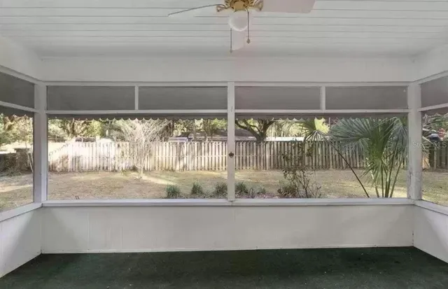 a view of a house with pool and a yard