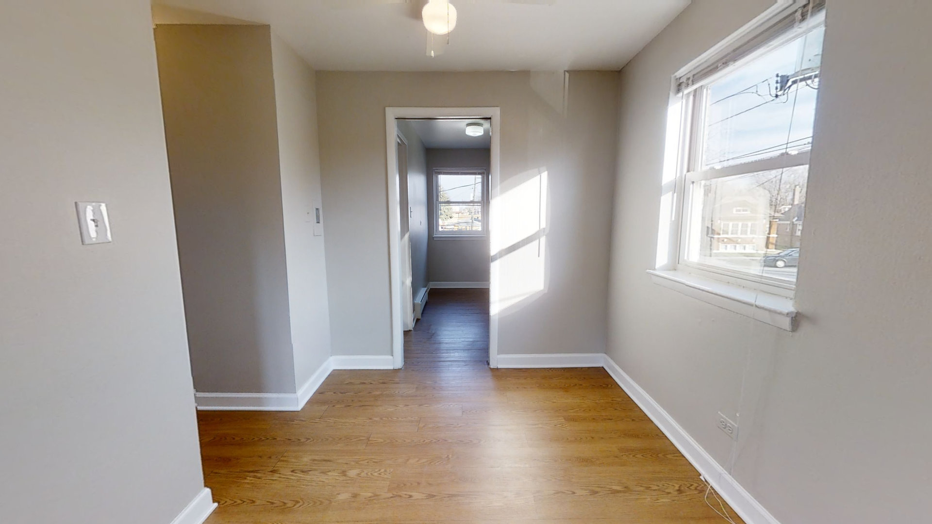6606 Windsor Avenue, Unit 2A Berwyn, IL 60402 - Photo 13 of 15 wooden floor in an empty room with a window