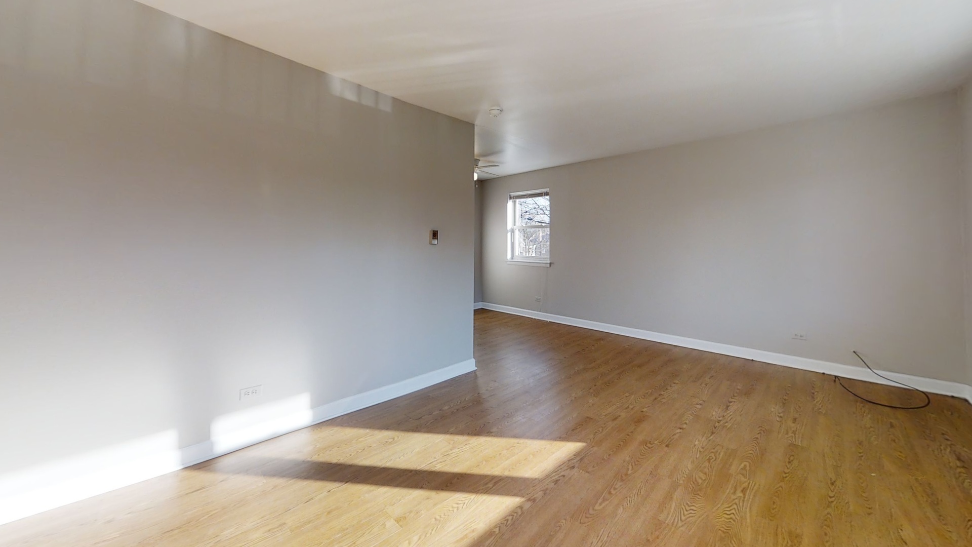 6606 Windsor Avenue, Unit 2A Berwyn, IL 60402 - Photo 4 of 15 an empty room with wooden floor and windows