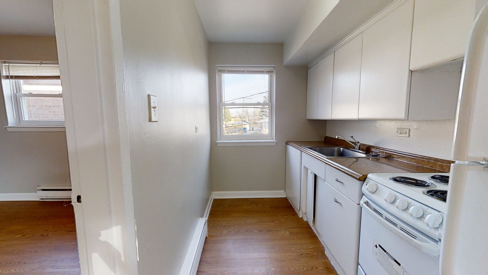 6606 Windsor Avenue, Unit 2A Berwyn, IL 60402 - Photo 5 of 15 a kitchen with cabinets appliances and a window