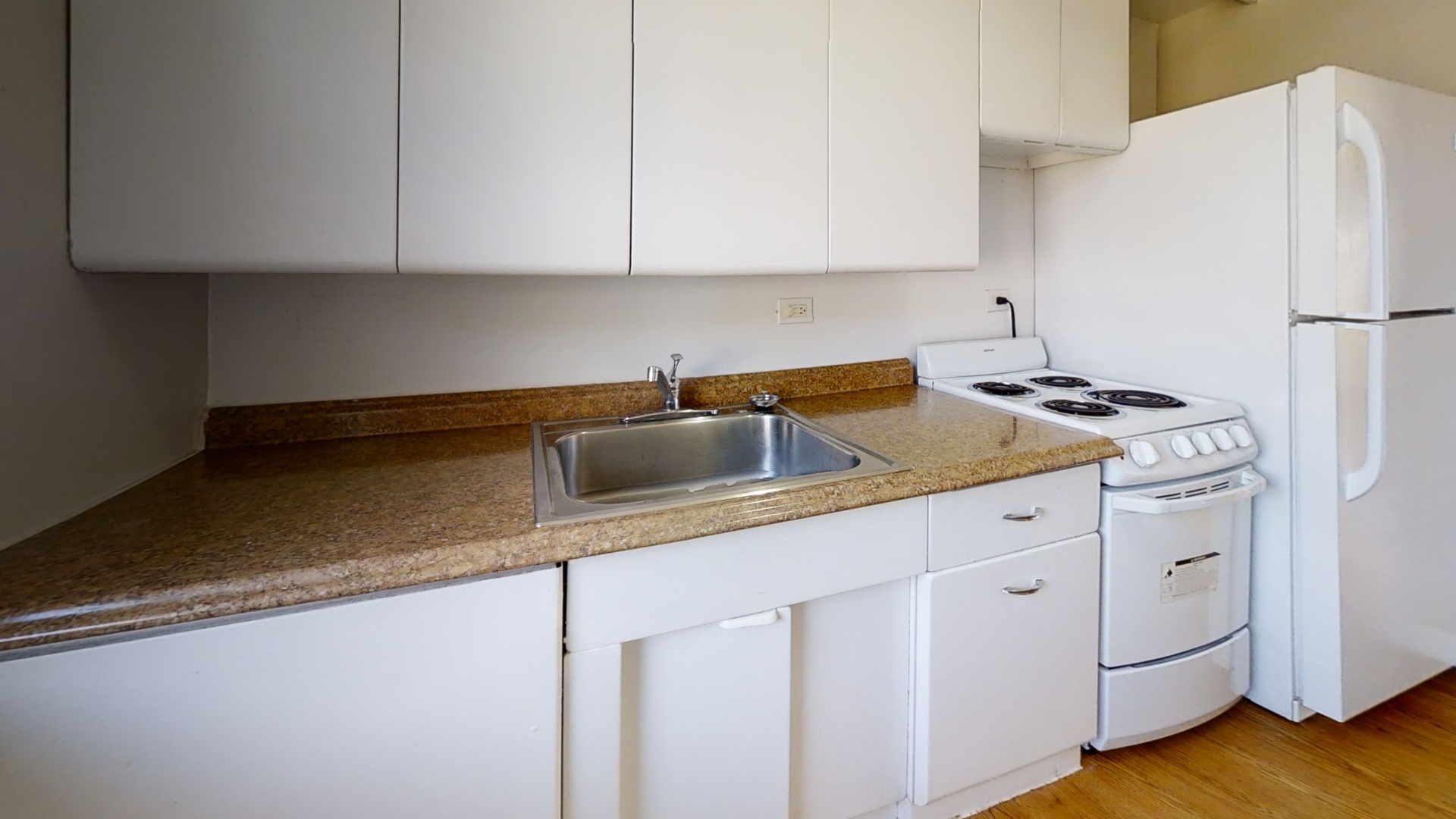 6606 Windsor Avenue, Unit 2A Berwyn, IL 60402 - Photo 6 of 15 a kitchen with granite countertop a sink cabinets and stainless steel appliances