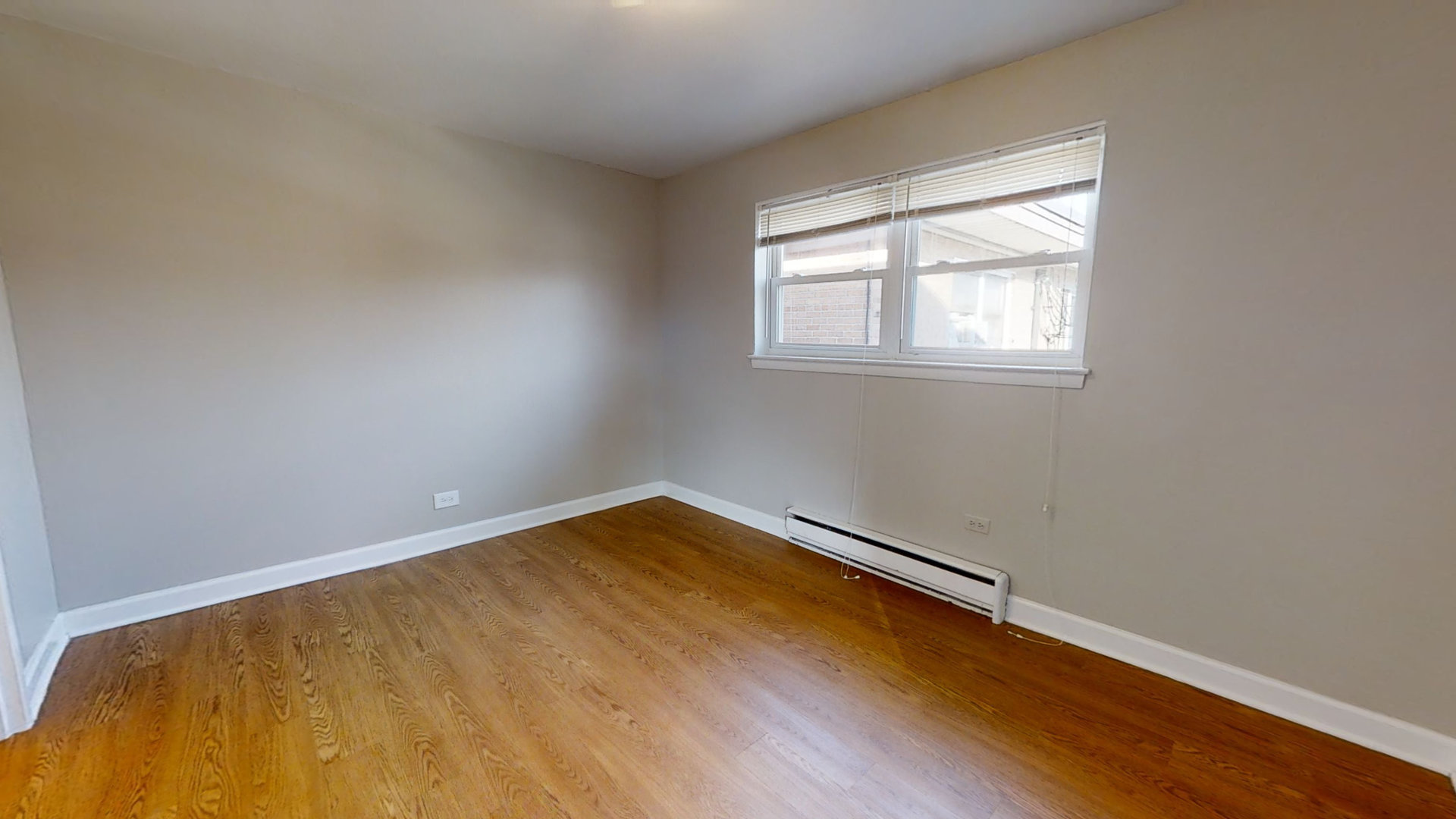 6606 Windsor Avenue, Unit 2A Berwyn, IL 60402 - Photo 8 of 15 an empty room with wooden floor and windows