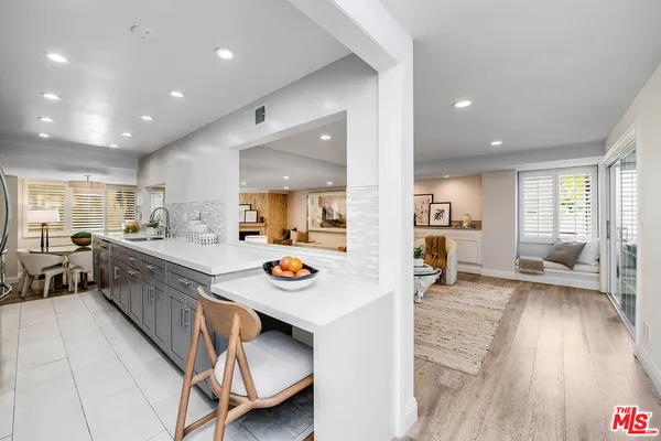 a view of kitchen with sink and living room