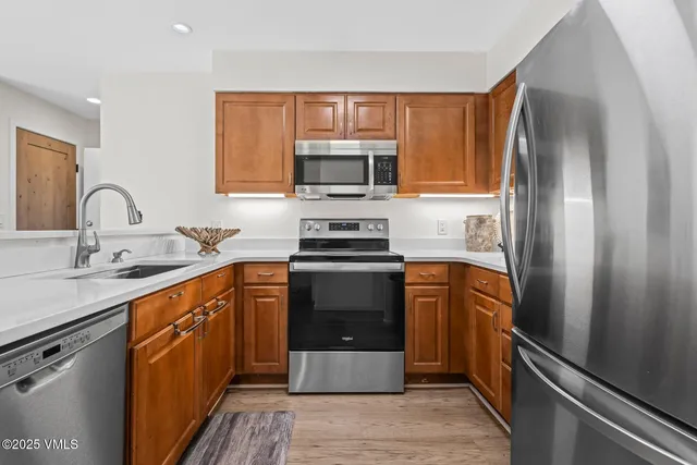 a kitchen with a refrigerator stove and sink
