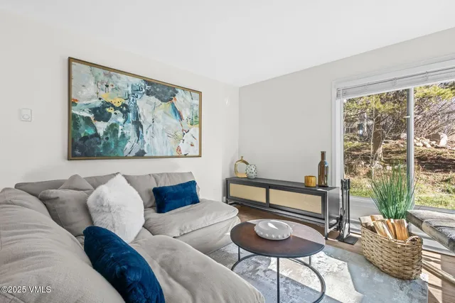 a living room with furniture and a large window