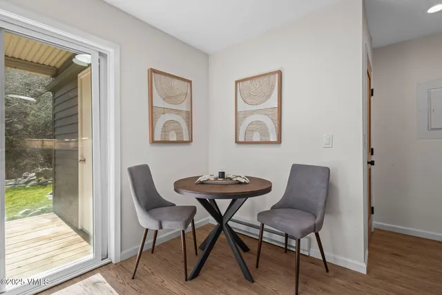 a view of a dining room with furniture and wooden floor