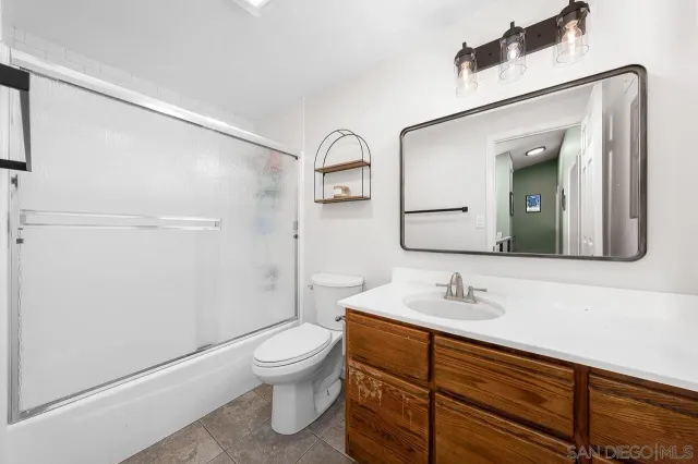 a bathroom with a toilet sink and shower