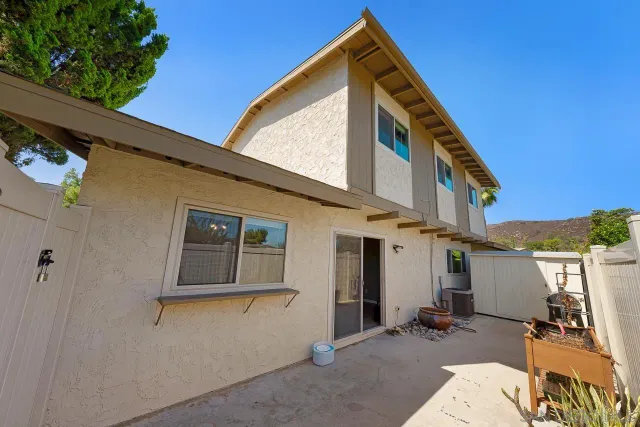 a view of a patio with table and chairs with wooden fence