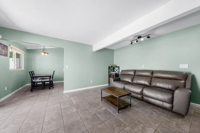 a living room with furniture and a piano