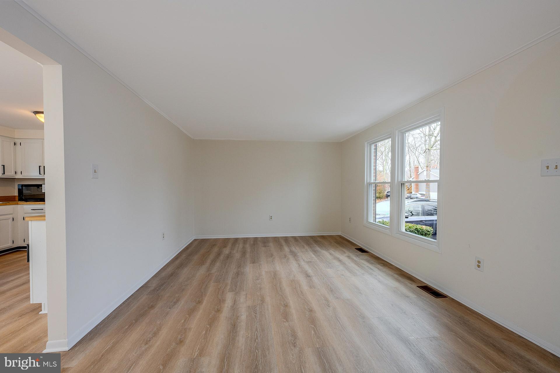 8414 Belding Court Brandywine, MD 20613 - Photo 11 of 37 an empty room with wooden floor and windows