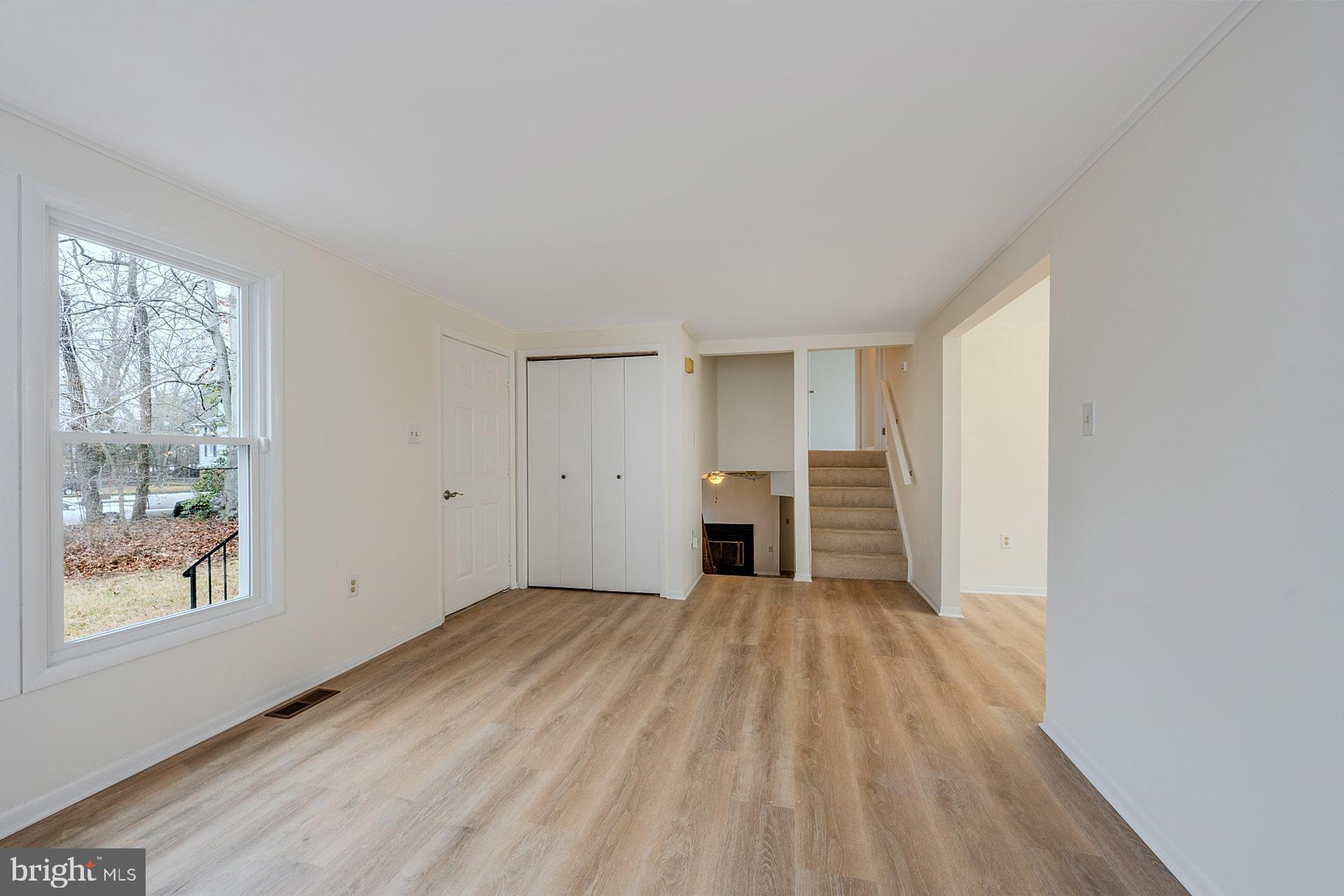 8414 Belding Court Brandywine, MD 20613 - Photo 12 of 37 a view of an empty room with a window and wooden floor