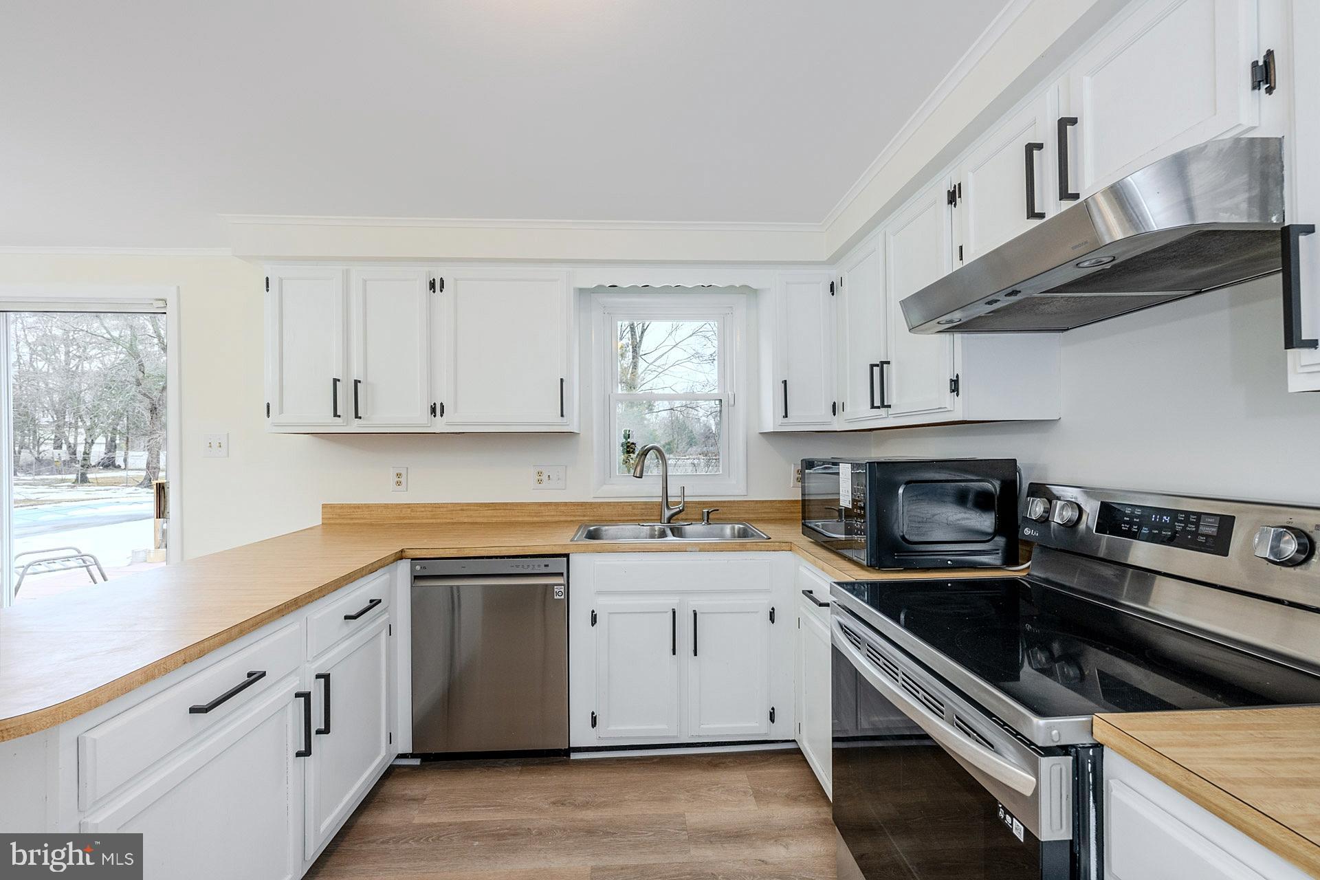 8414 Belding Court Brandywine, MD 20613 - Photo 15 of 37 a kitchen with cabinets stainless steel appliances a sink and a window