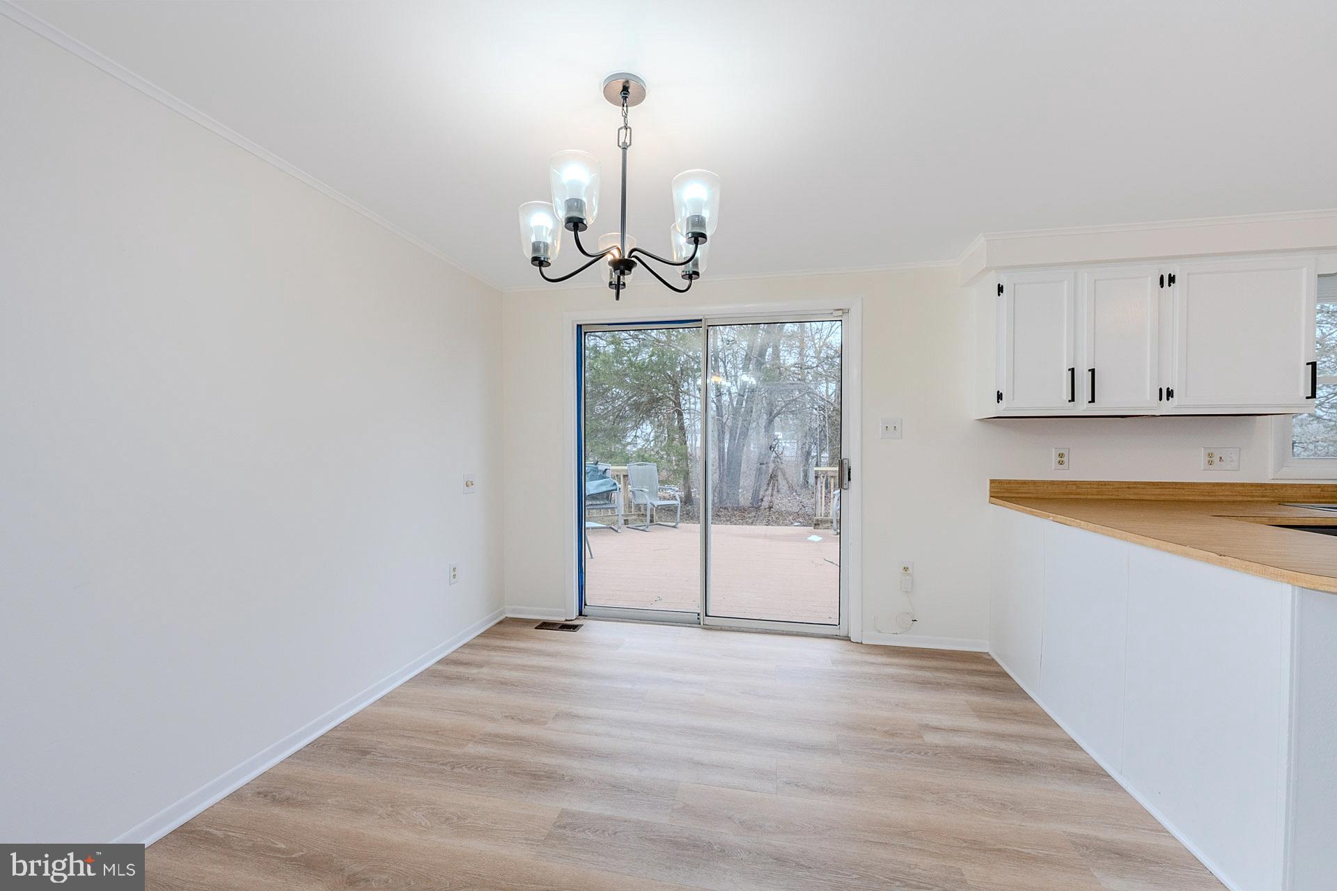 8414 Belding Court Brandywine, MD 20613 - Photo 17 of 37 a view of empty room with wooden floor and fan