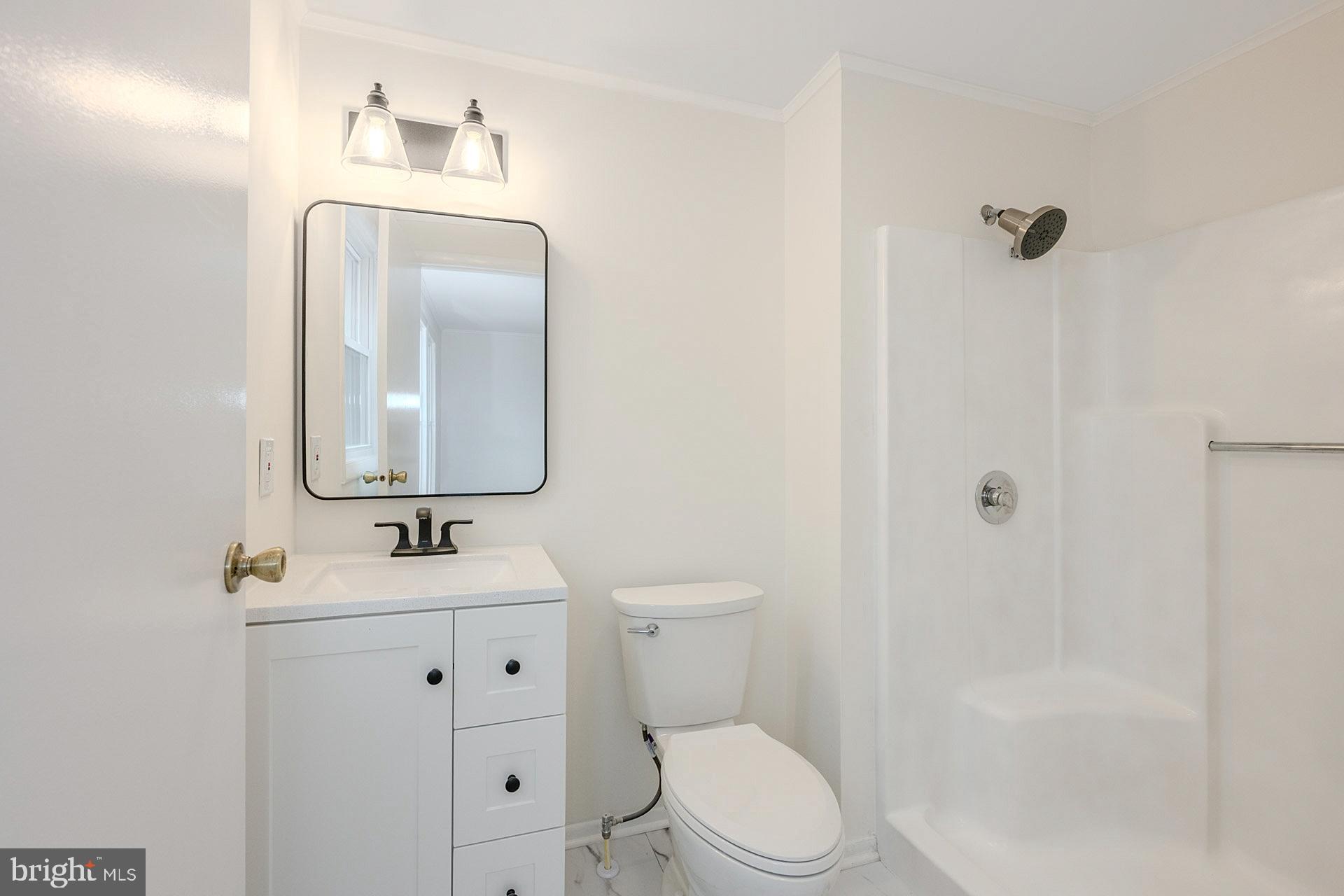 8414 Belding Court Brandywine, MD 20613 - Photo 21 of 37 a white toilet sitting next to a bathroom sink