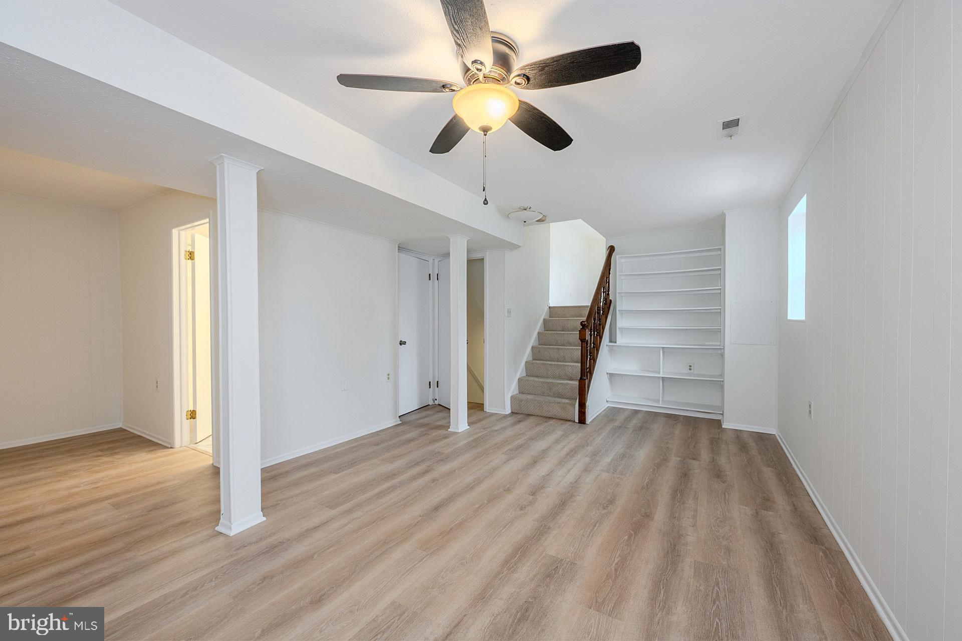 8414 Belding Court Brandywine, MD 20613 - Photo 27 of 37 wooden floor in an empty room with a chandelier fan