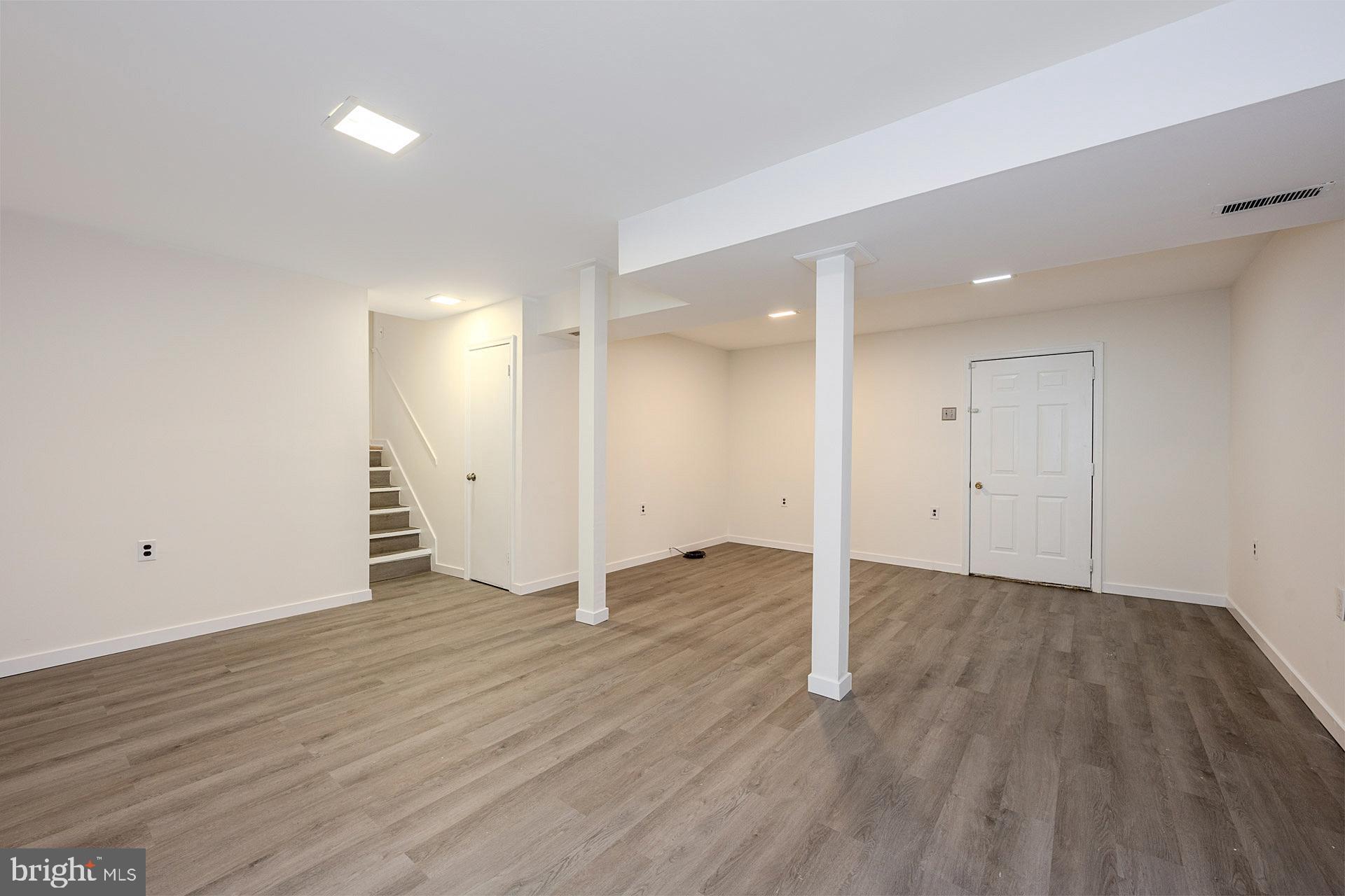 8414 Belding Court Brandywine, MD 20613 - Photo 30 of 37 an empty room with wooden floor