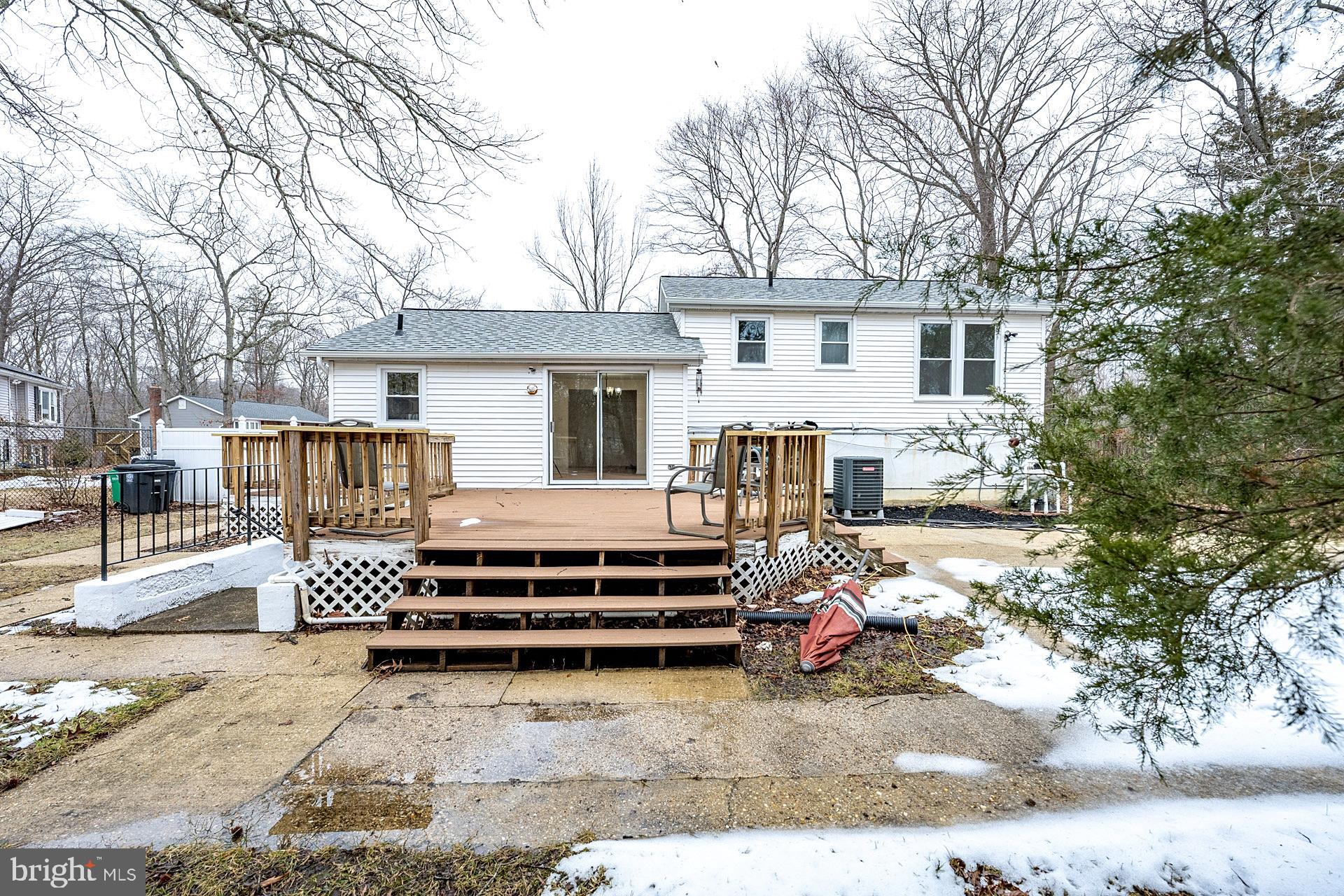 8414 Belding Court Brandywine, MD 20613 - Photo 37 of 37 a view of a white house with a large tree and wooden fence