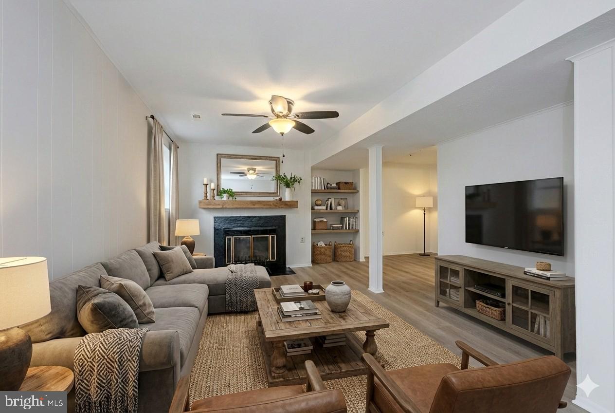 8414 Belding Court Brandywine, MD 20613 - Photo 7 of 37 a living room with furniture a fireplace and a flat screen tv