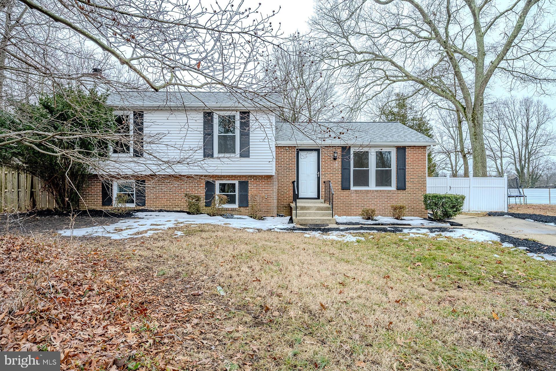 8414 Belding Court Brandywine, MD 20613 - Photo 9 of 37 a front view of a house with a yard and garage