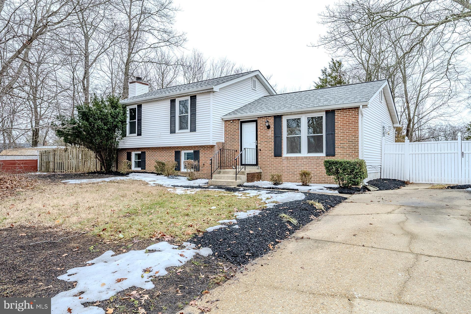 8414 Belding Court Brandywine, MD 20613 - Photo 10 of 37 a front view of a house with a yard and garage