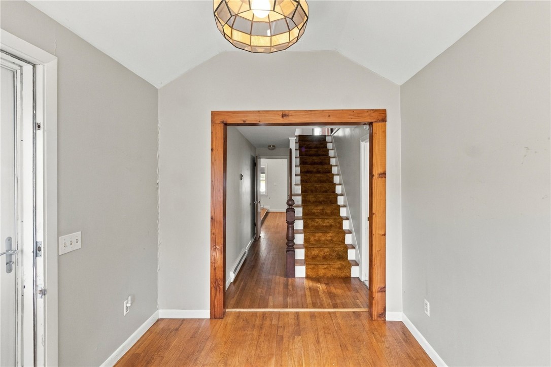 168 Colonel John Gardner Road Narragansett, RI 02882 - Photo 7 of 44 View from foyer into living/dining space and stairs up