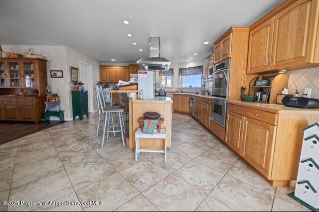 1040 Pronghorn Road Craig, CO 81625 - Photo 18 of 70 a kitchen with stainless steel appliances a refrigerator a stove a sink dishwasher and a dining table with wooden cabinet