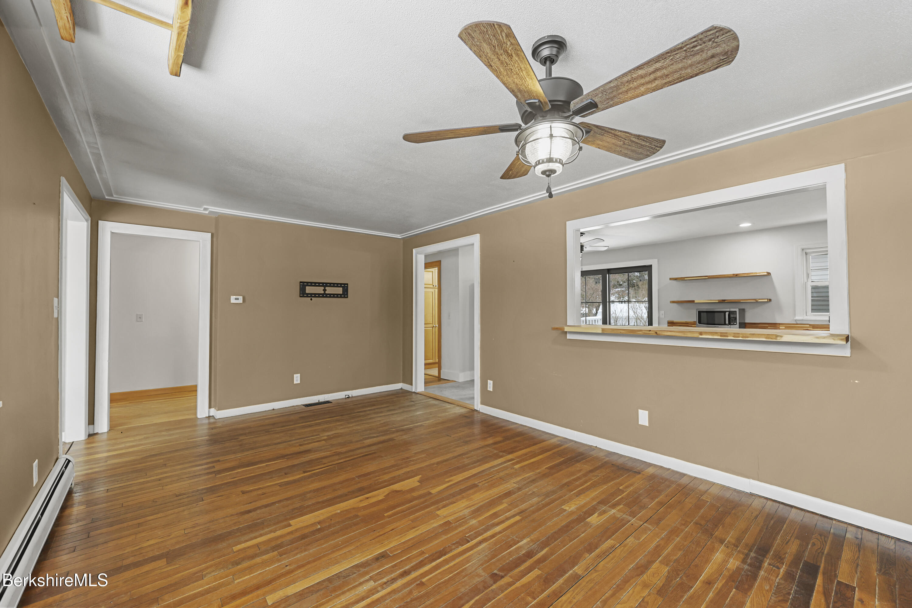 290 East Center Street Lee, MA 01238 - Photo 11 of 47 a view of an empty room with window and wooden floor