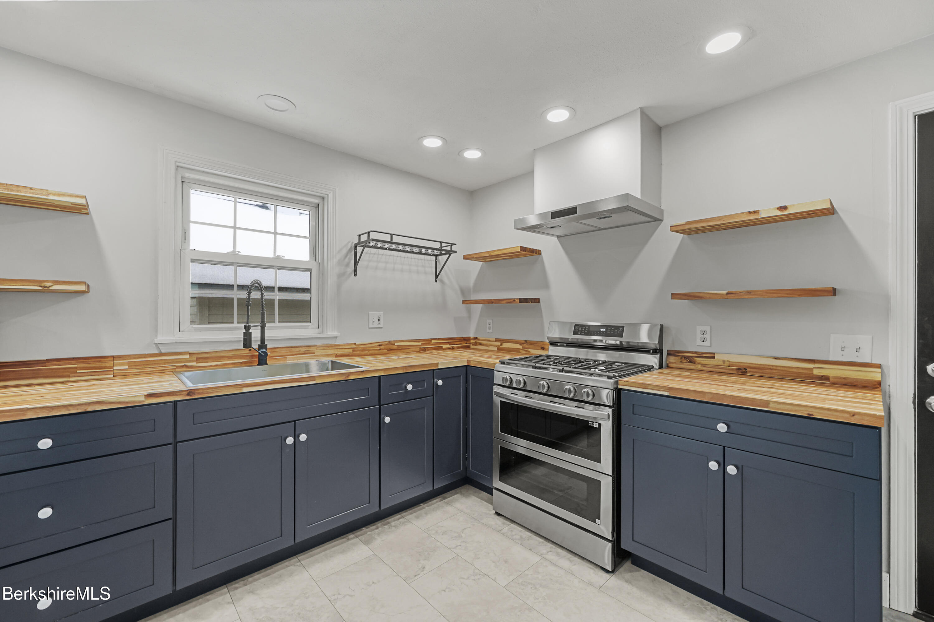 290 East Center Street Lee, MA 01238 - Photo 18 of 47 a kitchen with stainless steel appliances granite countertop a sink and stove