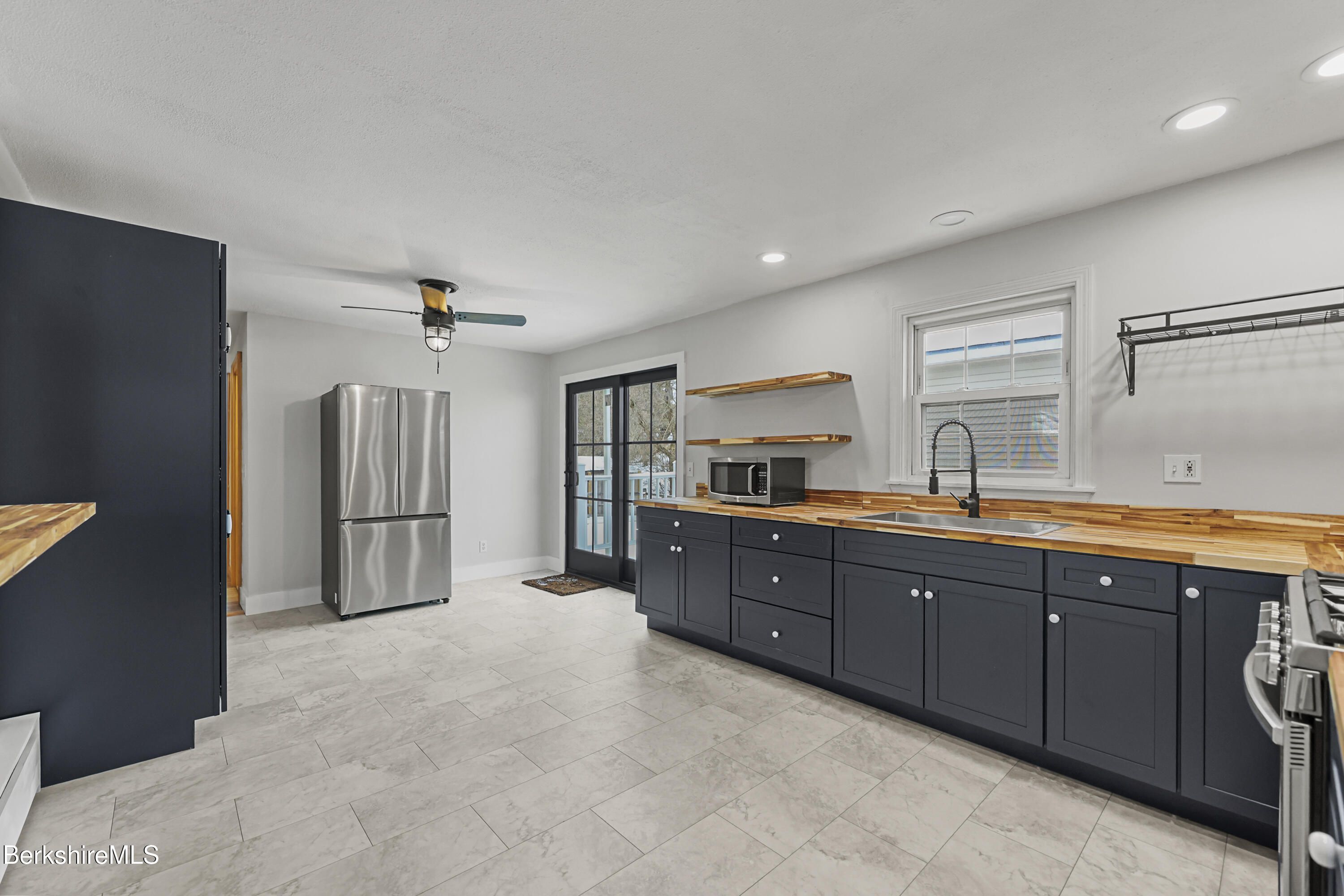 290 East Center Street Lee, MA 01238 - Photo 20 of 47 a large kitchen with stainless steel appliances granite countertop a refrigerator and a sink