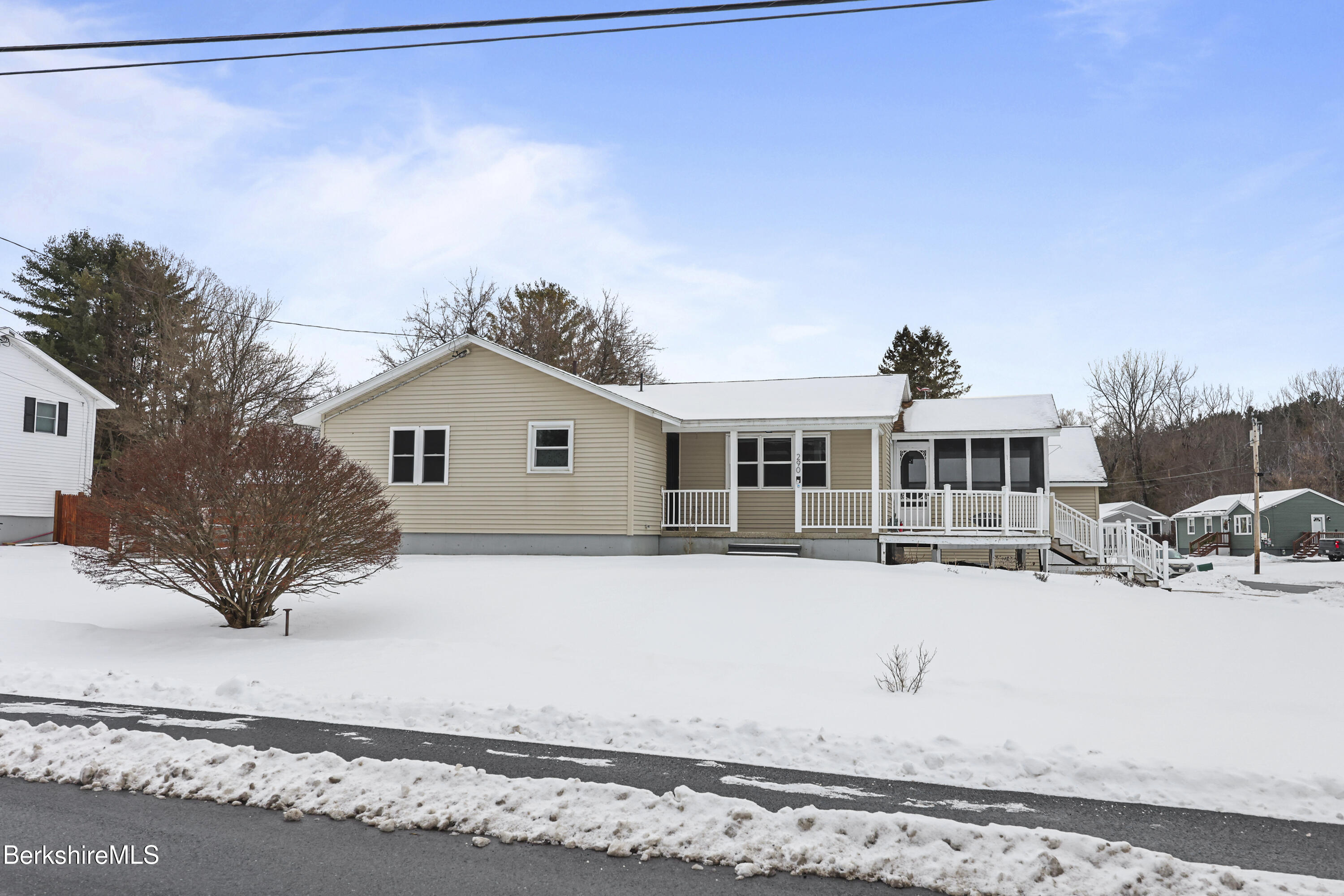 290 East Center Street Lee, MA 01238 - Photo 2 of 47 a front view of a house with a yard covered with snow