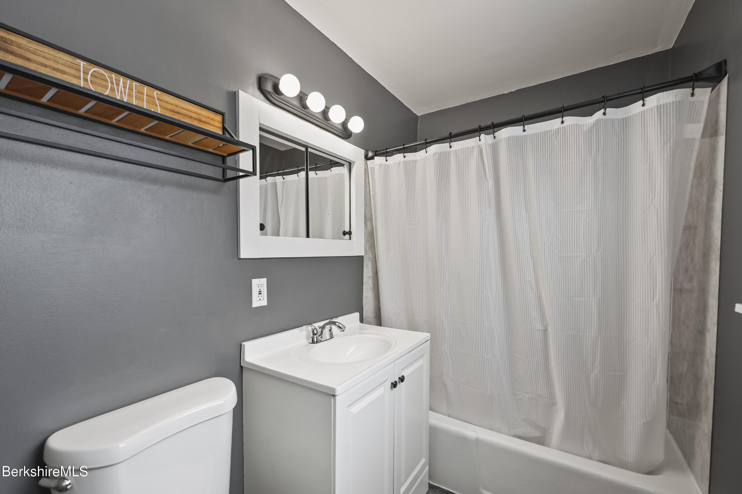 290 East Center Street Lee, MA 01238 - Photo 28 of 47 a bathroom with a sink a toilet and shower curtain