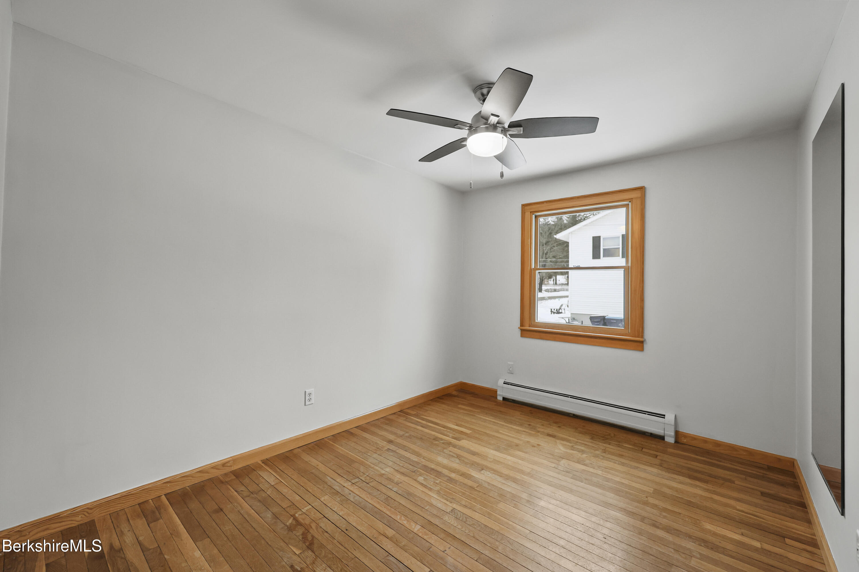 290 East Center Street Lee, MA 01238 - Photo 29 of 47 a view of empty room with wooden floor and fan
