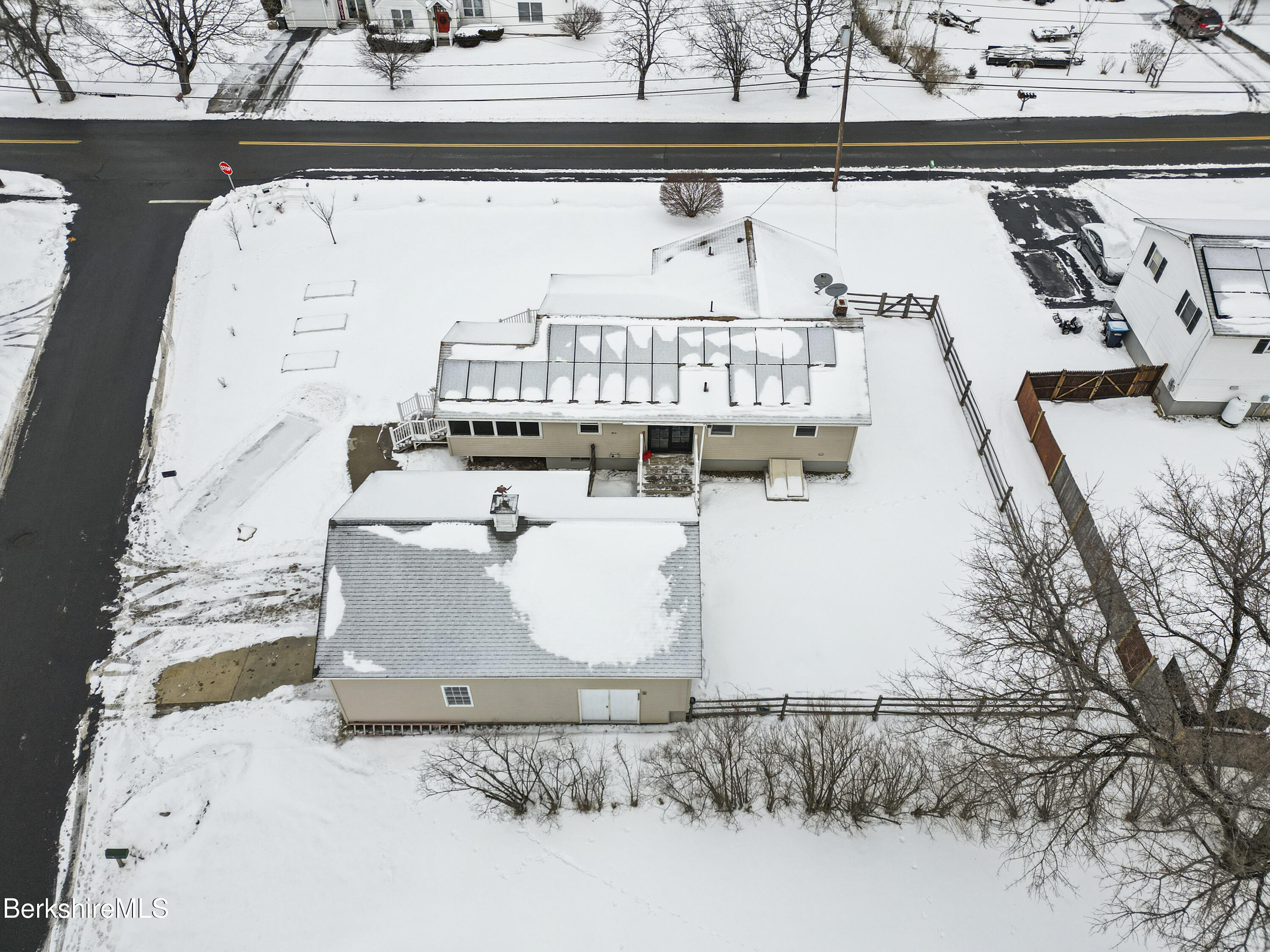 290 East Center Street Lee, MA 01238 - Photo 46 of 47 a white building with glass top table and chairs