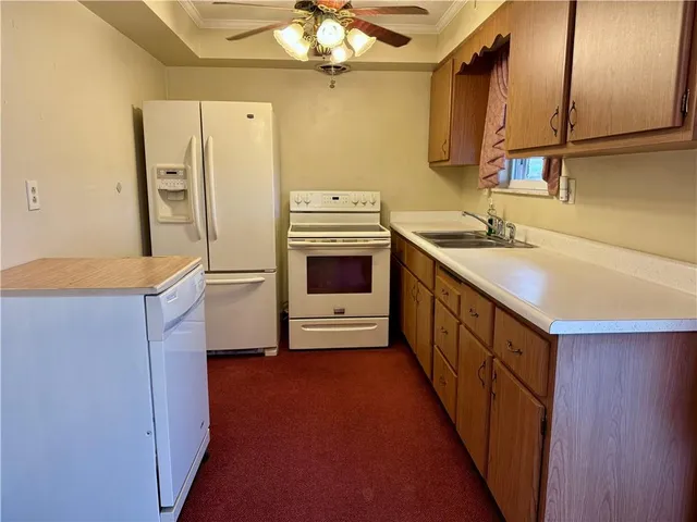 a kitchen with stainless steel appliances a sink and a refrigerator
