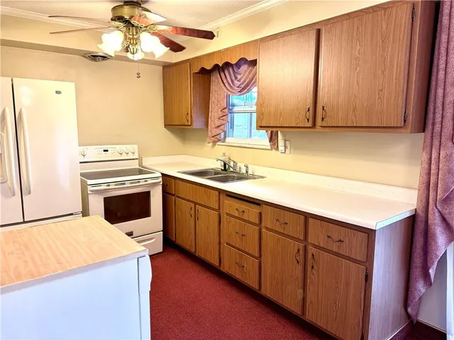 a kitchen with stainless steel appliances a stove a sink and a refrigerator