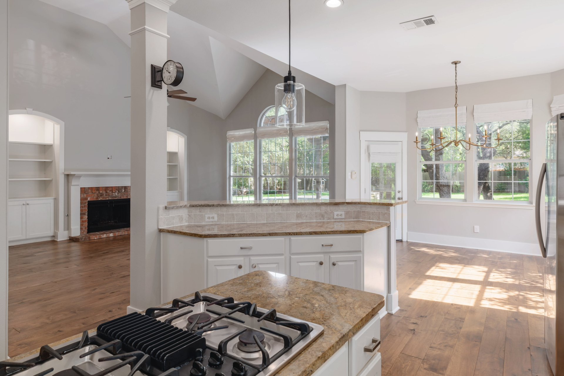 5512 Ballenton Lane Austin, TX 78739 - Photo 13 of 40 An open concept design seamlessly connects the culinary space to a generous living area with a fireplace.